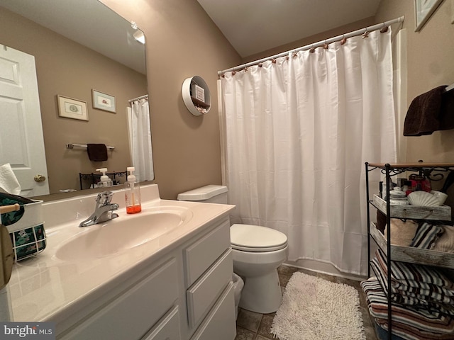 bathroom with tile patterned floors, walk in shower, vanity, vaulted ceiling, and toilet