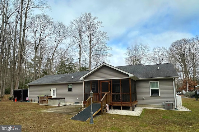 rear view of house with a jacuzzi, central AC unit, a lawn, and a sunroom