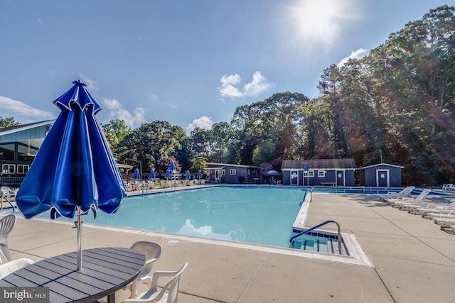 view of swimming pool with a patio