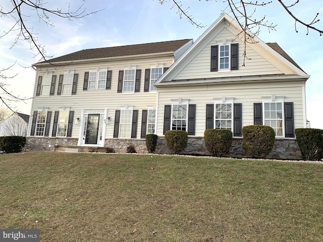 colonial home with a front yard