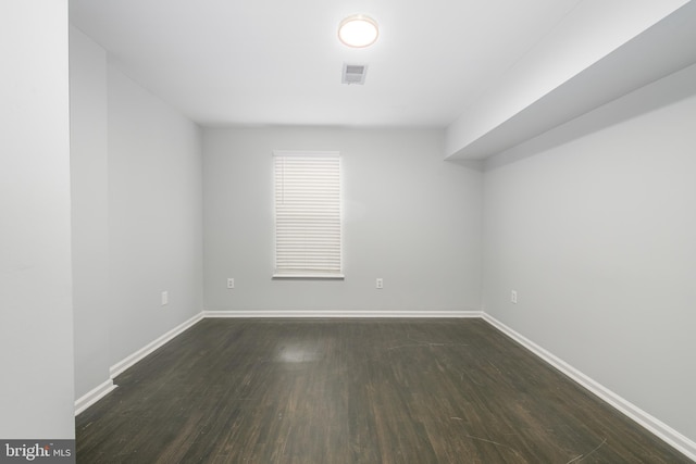 empty room featuring dark hardwood / wood-style flooring