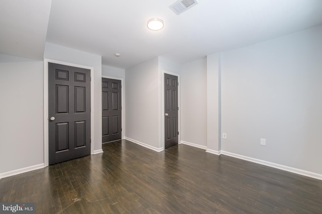 spare room featuring dark wood-type flooring