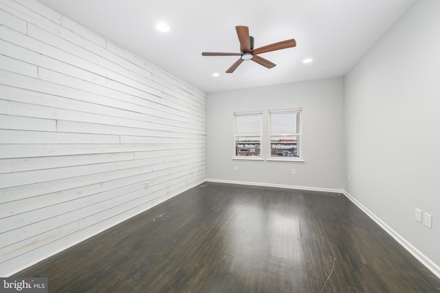 unfurnished room featuring ceiling fan and dark hardwood / wood-style flooring