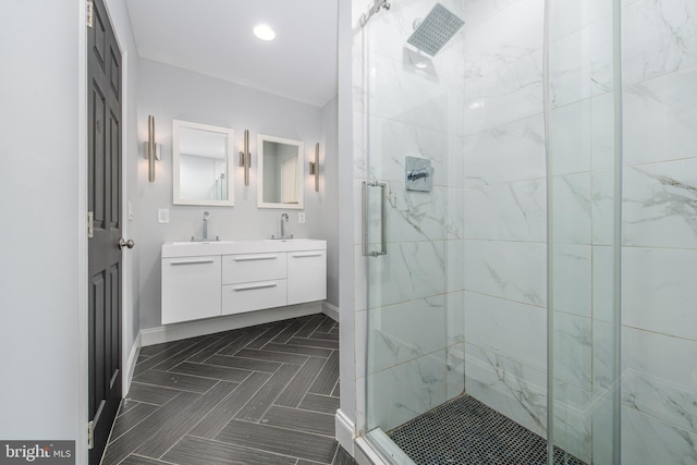 bathroom featuring vanity and a shower with door