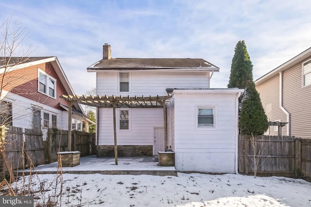 snow covered house featuring a pergola