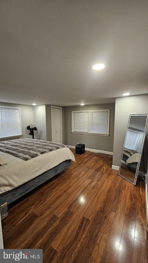 bedroom with dark hardwood / wood-style floors