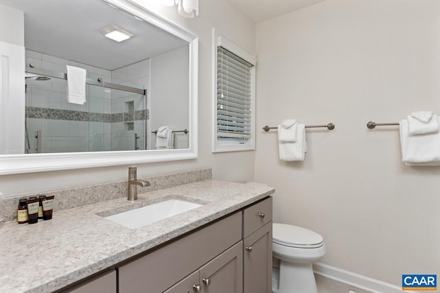 bathroom with vanity, toilet, and walk in shower