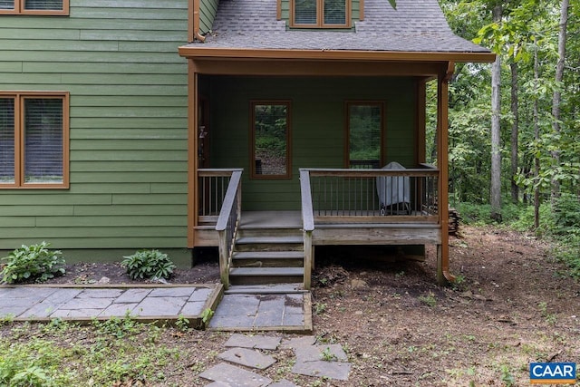 view of exterior entry featuring a porch