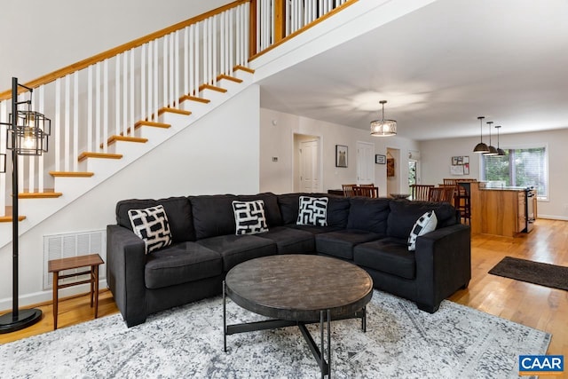 living room featuring a chandelier and hardwood / wood-style floors