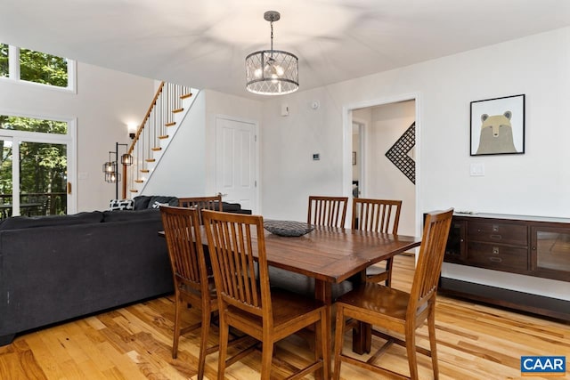 dining room featuring a notable chandelier and light hardwood / wood-style floors