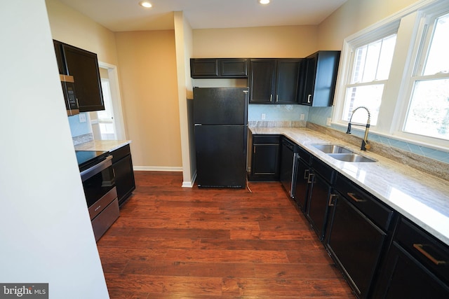 kitchen featuring dark hardwood / wood-style floors, sink, light stone countertops, and stainless steel appliances