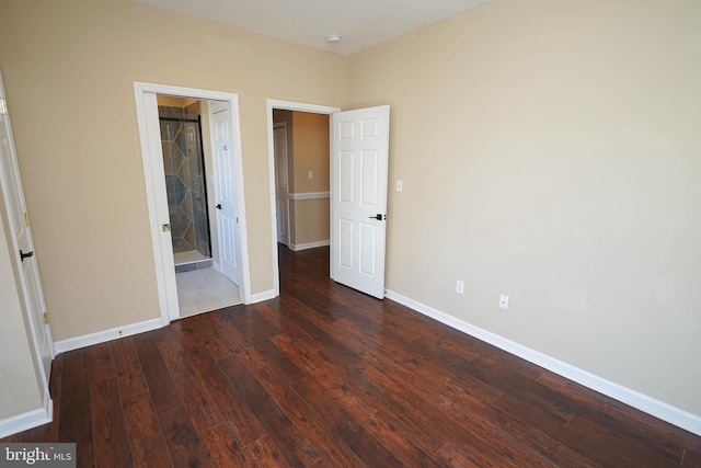 unfurnished bedroom featuring dark hardwood / wood-style floors