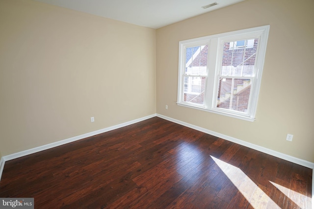 unfurnished room with dark hardwood / wood-style floors