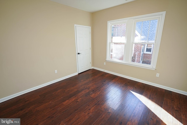 spare room featuring dark hardwood / wood-style flooring