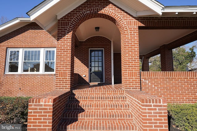 view of exterior entry featuring a porch