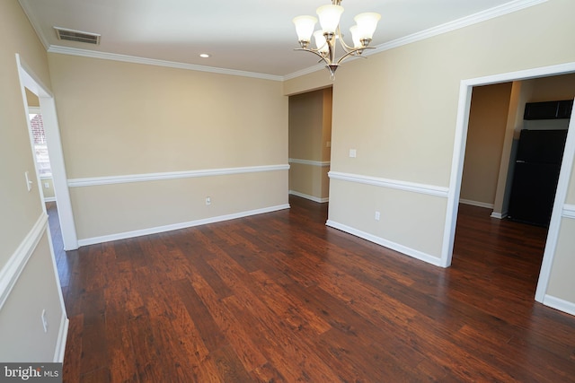 unfurnished room featuring dark hardwood / wood-style floors, an inviting chandelier, and crown molding