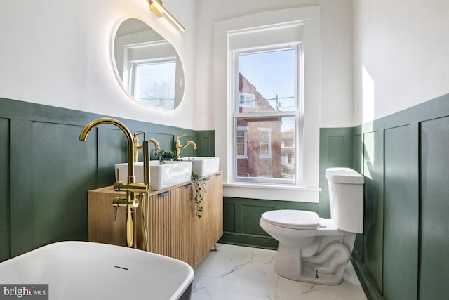 bathroom featuring toilet, sink, and a tub