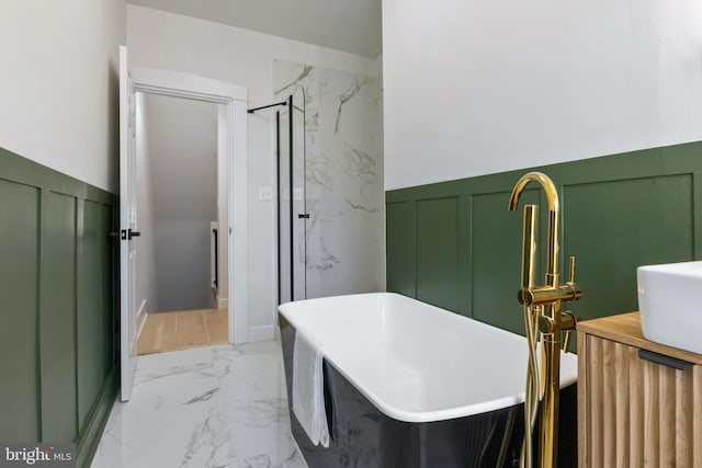 bathroom featuring separate shower and tub and vanity