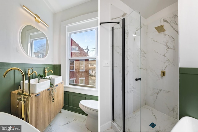 bathroom with a shower with door, vanity, and toilet