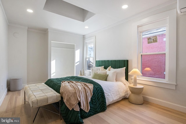 bedroom with crown molding, wood-type flooring, and a wall mounted air conditioner