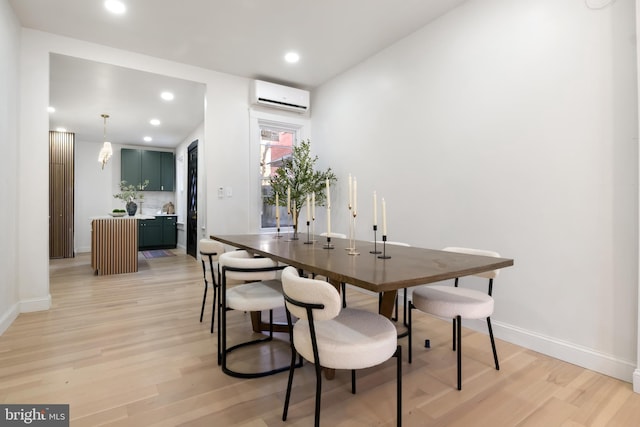 dining room featuring light hardwood / wood-style floors and a wall mounted AC