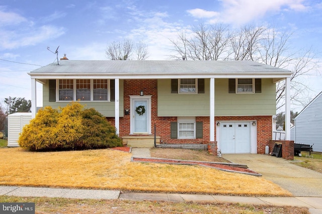 bi-level home featuring a garage and a front yard