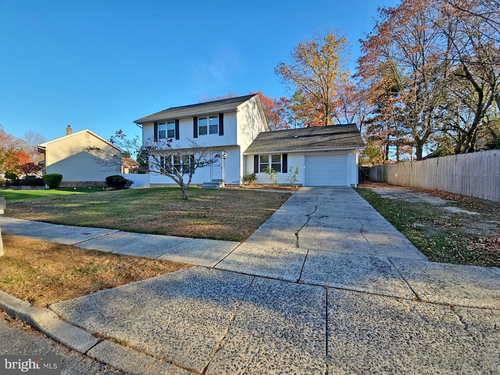 view of front of house featuring a garage and a front yard