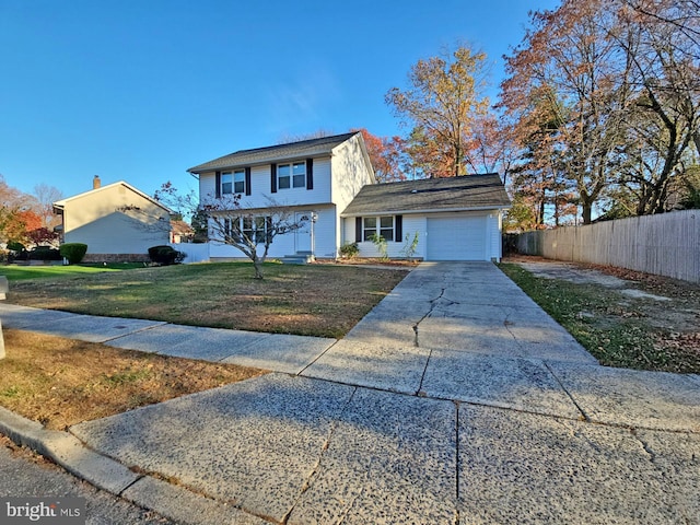 view of front of house featuring a garage and a front yard