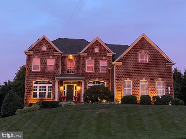 view of front of property with a yard