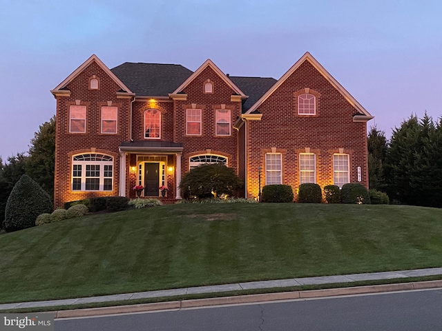 front facade with a yard