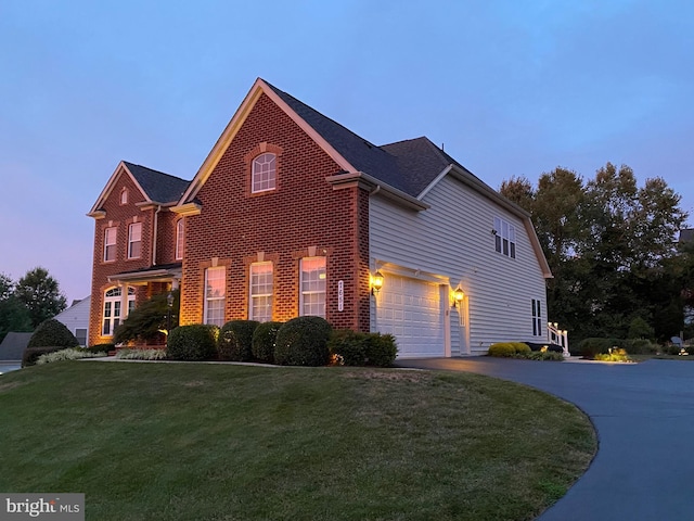 property exterior at dusk featuring a garage and a lawn