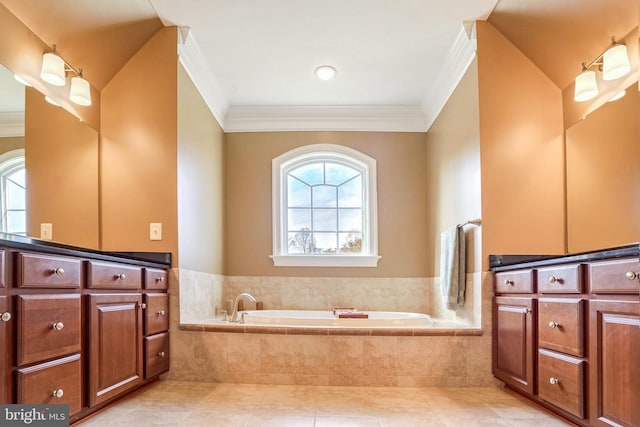 bathroom featuring tile patterned floors, tiled tub, vanity, and ornamental molding