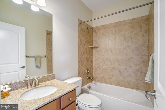 full bathroom with vanity, tiled shower / bath combo, and toilet