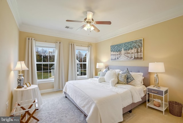 carpeted bedroom featuring ceiling fan and crown molding