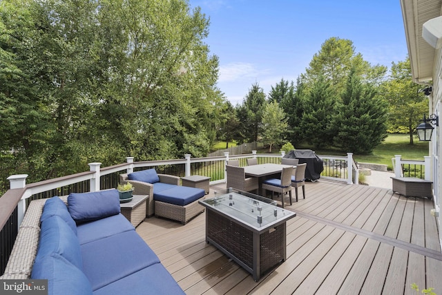 wooden terrace with area for grilling and an outdoor hangout area