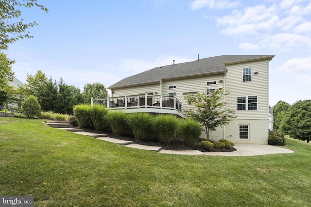 rear view of property with a lawn and a wooden deck