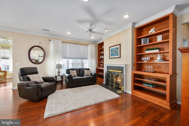 living room with dark wood-type flooring, a wealth of natural light, and built in shelves