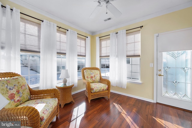 sitting room featuring ceiling fan, ornamental molding, and dark hardwood / wood-style floors