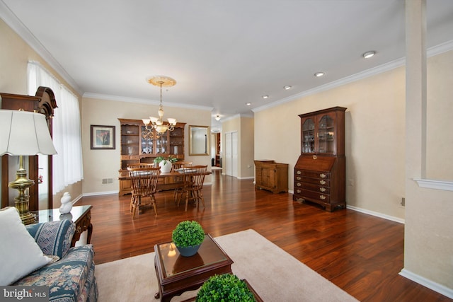 living room featuring a notable chandelier, crown molding, and dark wood-type flooring