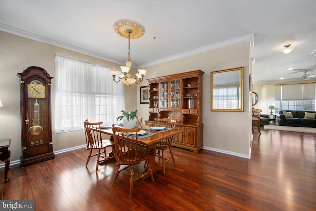 dining room featuring ornamental molding, dark hardwood / wood-style floors, and an inviting chandelier