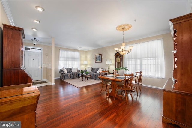 dining room featuring an inviting chandelier, crown molding, and dark hardwood / wood-style flooring