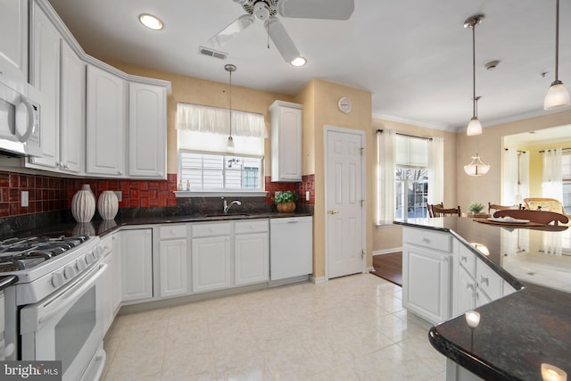 kitchen featuring decorative light fixtures, white cabinetry, and white appliances