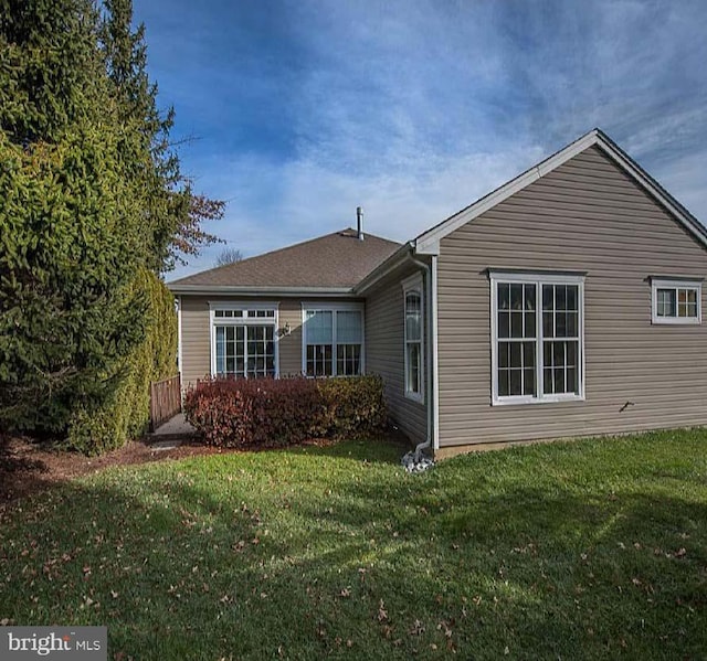 rear view of house with a yard