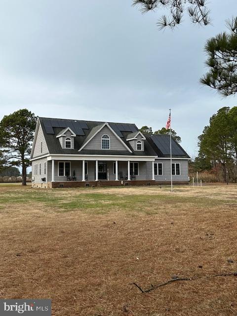 view of front of home with a porch and a front yard