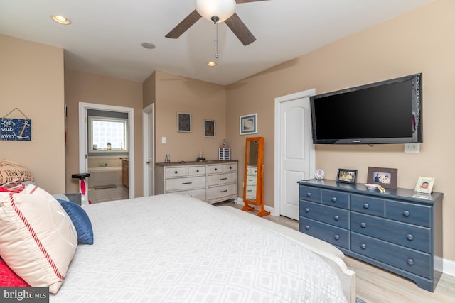 bedroom featuring ensuite bath, ceiling fan, and light wood-type flooring