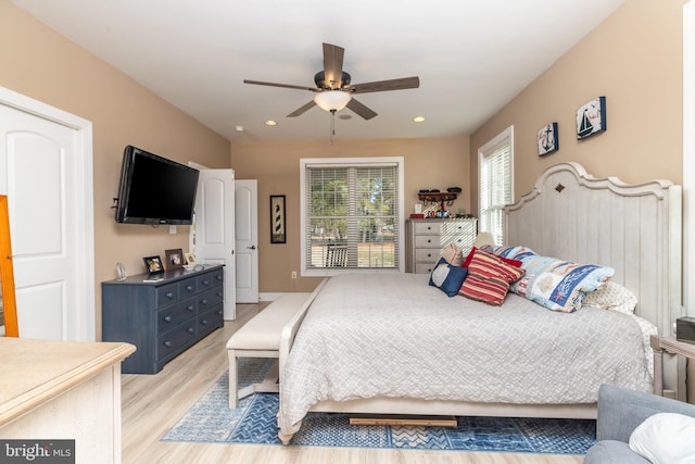 bedroom with ceiling fan and light wood-type flooring