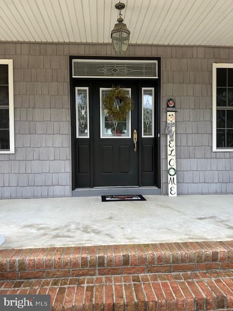 view of exterior entry with a porch