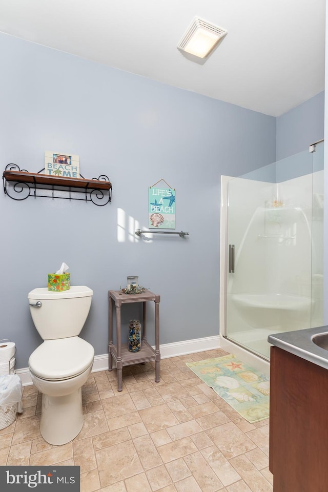 bathroom featuring a shower with door, vanity, and toilet