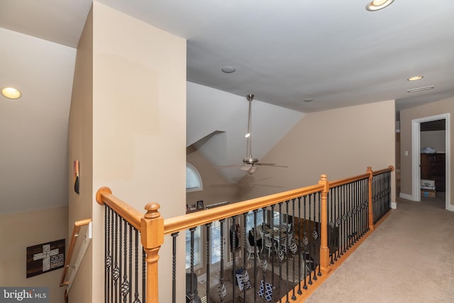 hall with carpet flooring and vaulted ceiling