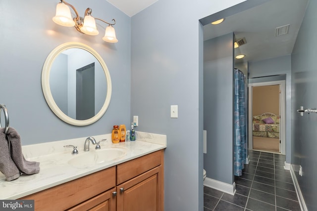 bathroom with tile patterned flooring, vanity, and toilet